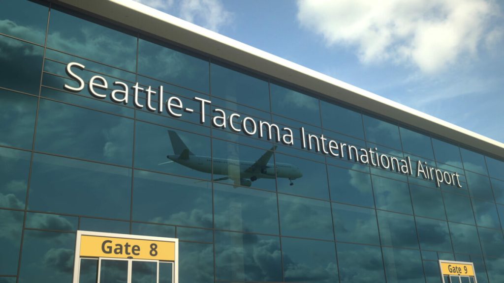 Commercial,Plane,Landing,Reflecting,In,The,Windows,With,Seattle-tacoma,International
